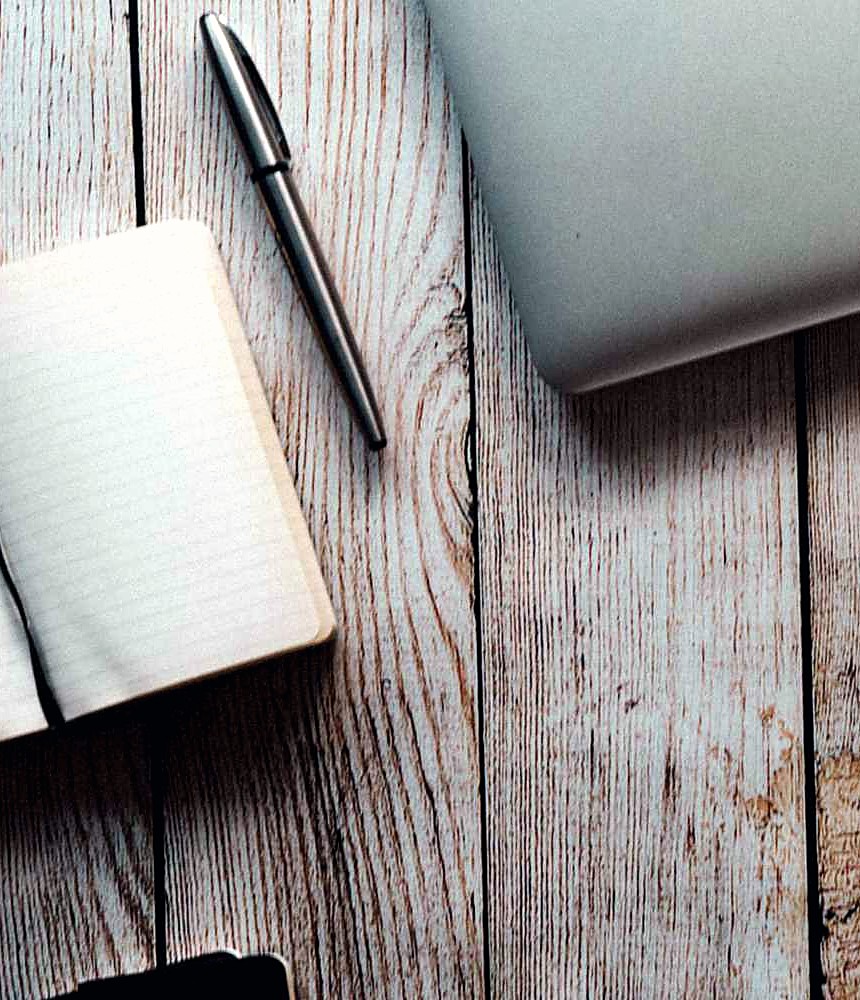 A quiet desk at home — notebook, pen and laptop, ready for a study session